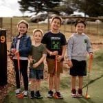 Photo of children standing and smiling at a Shanx Mini Golf Course